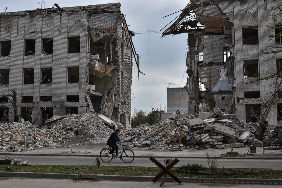 A local woman rides a bicycle in front of a building which was destroyed by a Russian airstrike in the frontline town of Orikhiv, Ukraine, on Thursday, April 18, 2024. (AP Photo/Andriy Andriyenko) A local woman rides a bicycle in front of a building which was destroyed by a Russian airstrike in the frontline town of Orikhiv, Ukraine, on Thursday, April 18, 2024. (AP Photo/Andriy Andriyenko)