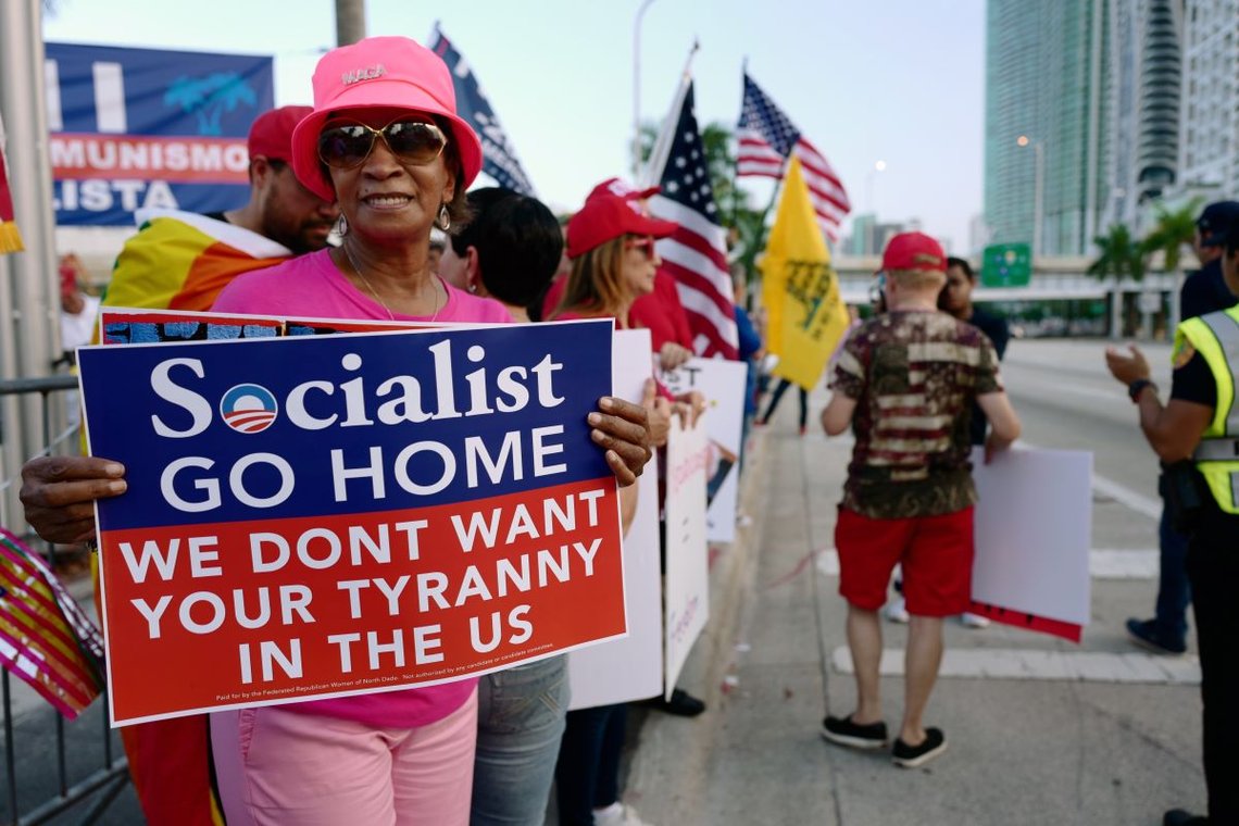 Miami, Florida/USA-June 26, 2019: Protesters outside of the Adrienne Arsht Center before the first night of the Democratic presidential debate hold banners about Medicare, anti-socialism and freedom. Photo: Shutterstock by Hernando Sorzano, United States. Miami, Florida/USA-June 26, 2019: Protesters outside of the Adrienne Arsht Center before the first night of the Democratic presidential debate hold banners about Medicare, anti-socialism and freedom. Photo: Shutterstock by Hernando Sorzano, United States.