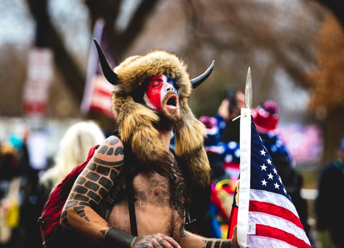 Washington, D.C. | U.S.A. - Jan 6th, 2021: Trump Initiated Riots at the Capitol: QAnon Shaman, Jake Angeli. Photo: Shutterstock by Johnny Silvercloud, United States. Washington, D.C. | U.S.A. - Jan 6th, 2021: Trump Initiated Riots at the Capitol: QAnon Shaman, Jake Angeli. Photo: Shutterstock by Johnny Silvercloud, United States.