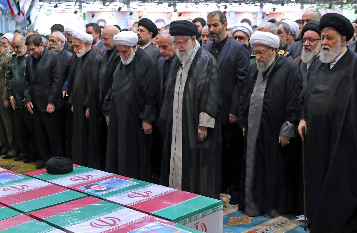 In this photo released by the office of the Iranian supreme leader, Supreme Leader Ayatollah Ali Khamenei, center with black turban, leads a prayer over the flag-draped coffins of the late President Ebrahim Raisi and his companions who were killed in a helicopter crash on Sunday in a mountainous region of the country's northwest, at the Tehran University campus, during a funeral ceremony for them in Tehran, Iran, Wednesday, May 22, 2024. (Office of the Iranian Supreme Leader via AP) In this photo released by the office of the Iranian supreme leader, Supreme Leader Ayatollah Ali Khamenei, center with black turban, leads a prayer over the flag-draped coffins of the late President Ebrahim Raisi and his companions who were killed in a helicopter crash on Sunday in a mountainous region of the country's northwest, at the Tehran University campus, during a funeral ceremony for them in Tehran, Iran, Wednesday, May 22, 2024. (Office of the Iranian Supreme Leader via AP)