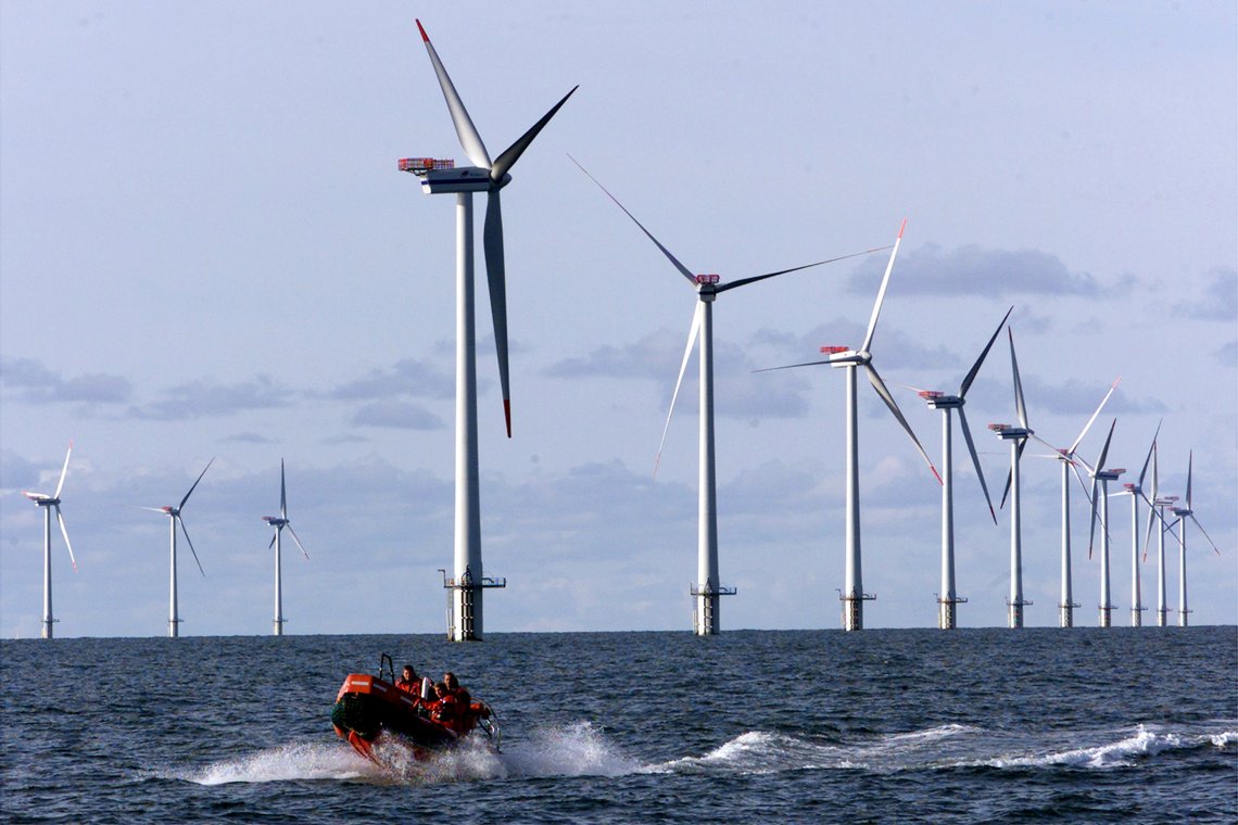 FILE - A speed rubber-boat passes along the over all 110 meters high offshore wind mills set up in the North Sea, 14 kilometers west of the small village of Blavand near Esbjerg, Denmark, on in this Oct. 30, 2002 file picture. Germany wants to create a web of power lines connecting the country’s offshore wind parks with those of its North Sea neighbors to smooth out bottlenecks in the European energy market. Governments in northwestern Europe are hoping that wind power at sea will provide a large share of their future clean energy needs. (AP Photo/Heribert Proepper) FILE - A speed rubber-boat passes along the over all 110 meters high offshore wind mills set up in the North Sea, 14 kilometers west of the small village of Blavand near Esbjerg, Denmark, on in this Oct. 30, 2002 file picture. Germany wants to create a web of power lines connecting the country’s offshore wind parks with those of its North Sea neighbors to smooth out bottlenecks in the European energy market. Governments in northwestern Europe are hoping that wind power at sea will provide a large share of their future clean energy needs. (AP Photo/Heribert Proepper)