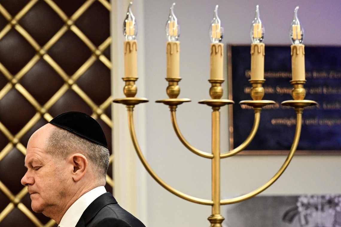 German Chancellor Olaf Scholz walks past a candle holder towards a podium to speak during a central commemoration ceremony to mark the 85th anniversary of the pogrom night in the Beth Zion synagogue in Berlin, Thursday, Nov. 9, 2023. Across Germany, in schools, city halls, synagogues, churches and parliament, people are coming together to commemorate the 85th anniversary of Kristallnacht — or the “Night of Broken Glass” — in which the Nazis terrorized Jews throughout Germany and Austria. (John Macdougall/Pool Photo via AP) German Chancellor Olaf Scholz walks past a candle holder towards a podium to speak during a central commemoration ceremony to mark the 85th anniversary of the pogrom night in the Beth Zion synagogue in Berlin, Thursday, Nov. 9, 2023. Across Germany, in schools, city halls, synagogues, churches and parliament, people are coming together to commemorate the 85th anniversary of Kristallnacht — or the “Night of Broken Glass” — in which the Nazis terrorized Jews throughout Germany and Austria. (John Macdougall/Pool Photo via AP)
