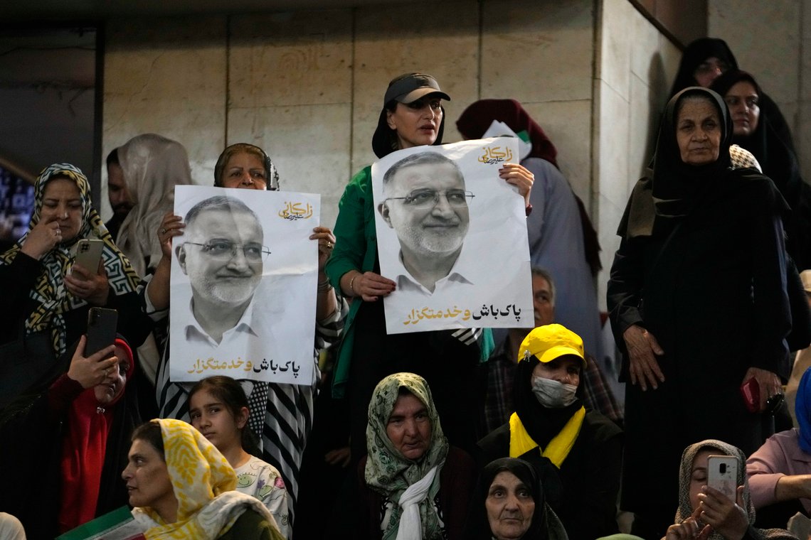 Supporters hold portraits of presidential candidate, Tehran Mayor Alireza Zakani, during a campaign meeting in Tehran, Iran, Sunday, June 23, 2024. Iran's Guardian Council has approved six candidates to run in the election to replace the late President Ebrahim Raisi, who was killed in a helicopter crash with seven other officials in May. (AP Photo/Vahid Salemi) Supporters hold portraits of presidential candidate, Tehran Mayor Alireza Zakani, during a campaign meeting in Tehran, Iran, Sunday, June 23, 2024. Iran's Guardian Council has approved six candidates to run in the election to replace the late President Ebrahim Raisi, who was killed in a helicopter crash with seven other officials in May. (AP Photo/Vahid Salemi)