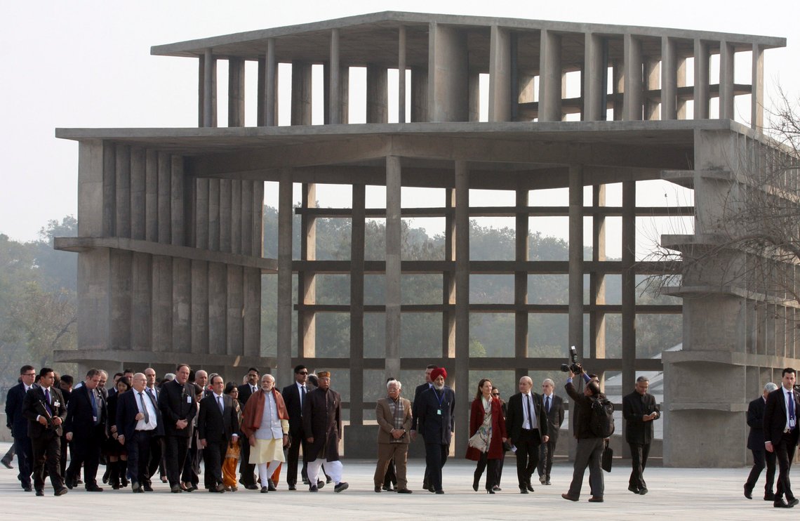 French President Francois Hollande, front row fifth from left, walks with Indian Prime Minister Narendra Modi, sixth left and others during a visit to the Capitol Complex in Chandigarh, India, Sunday, Jan.24, 2016. Hollande began a three-day visit to India on Sunday. Designed in the 1950s by Swiss-French architect Le Corbusier, Chandigarh is one of three places that France has pledged to help develop as so-called "smart cities" ó with clean water supplies, efficient sewage disposal and public transportation. (AP Photo/Kapil Sethi) French President Francois Hollande, front row fifth from left, walks with Indian Prime Minister Narendra Modi, sixth left and others during a visit to the Capitol Complex in Chandigarh, India, Sunday, Jan.24, 2016. Hollande began a three-day visit to India on Sunday. Designed in the 1950s by Swiss-French architect Le Corbusier, Chandigarh is one of three places that France has pledged to help develop as so-called "smart cities" ó with clean water supplies, efficient sewage disposal and public transportation. (AP Photo/Kapil Sethi)