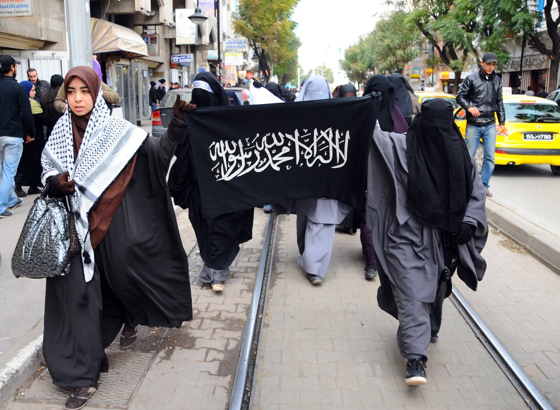 Tunisian Salafist women demonstrate near the French embassy in Tunis, Tunisia, Friday Jan. 20, 2012, in support of a Muslim woman who was fined in France for wearing a niqab Muslim veil. Sign reads: Allah is the Only God, and Mahommed is his Prophet.(AP Photo/Hassene Dridi) Tunisian Salafist women demonstrate near the French embassy in Tunis, Tunisia, Friday Jan. 20, 2012, in support of a Muslim woman who was fined in France for wearing a niqab Muslim veil. Sign reads: Allah is the Only God, and Mahommed is his Prophet.(AP Photo/Hassene Dridi)