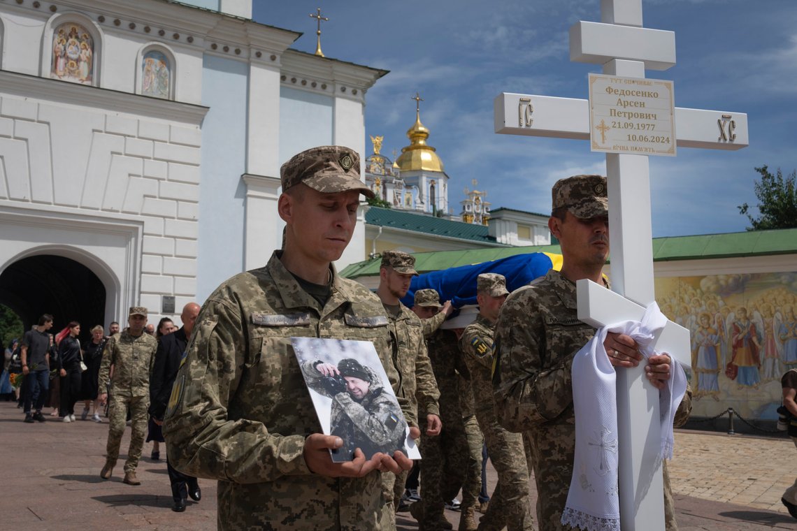 Soldiers carry the coffin of a Ukrainian serviceman, photographer Arsen Fedosenko, who was killed in a battle with the Russian troops, during the funeral ceremony at St. Michael Cathedral in Kyiv, Ukraine, Thursday, June 13, 2024. (AP Photo/Efrem Lukatsky) Soldiers carry the coffin of a Ukrainian serviceman, photographer Arsen Fedosenko, who was killed in a battle with the Russian troops, during the funeral ceremony at St. Michael Cathedral in Kyiv, Ukraine, Thursday, June 13, 2024. (AP Photo/Efrem Lukatsky)