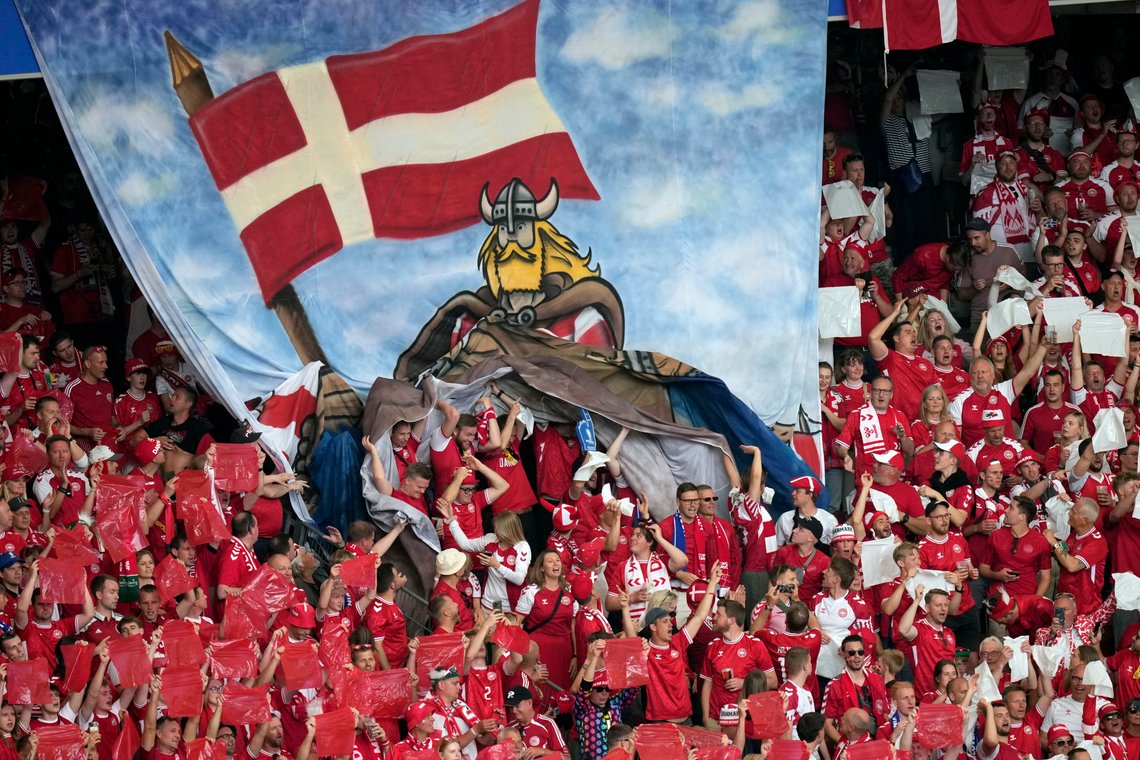 Denmark fans unfurl a banner in the stands before a Group C match between Slovenia and Denmark at the Euro 2024 soccer tournament in Stuttgart, Germany, Sunday, June 16, 2024. (AP Photo/Ariel Schalit) Denmark fans unfurl a banner in the stands before a Group C match between Slovenia and Denmark at the Euro 2024 soccer tournament in Stuttgart, Germany, Sunday, June 16, 2024. (AP Photo/Ariel Schalit)