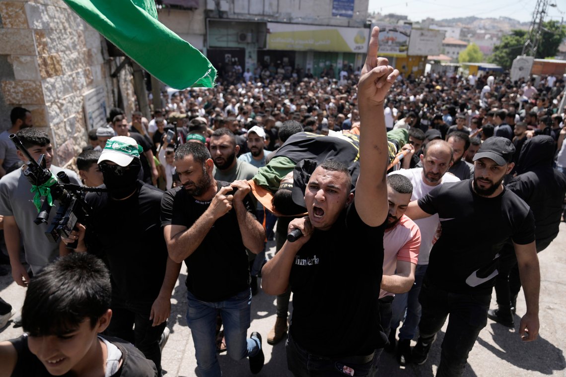 Mourners carry the body of Mustafa Marhi, an Islamic Jihad militant killed in a raid by Israeli forces in the village of Kafr Dan, near the West Bank city of Jenin, Wednesday, June 12, 2024. Hundreds of mourners gathered for the funeral of Palestinian men killed by Israeli fire during a raid in the northern West Bank village. A total of six men were killed by Israeli forces during Tuesday's raid on the village according to the Palestinian Health Ministry. (AP Photo/Majdi Mohammed) Mourners carry the body of Mustafa Marhi, an Islamic Jihad militant killed in a raid by Israeli forces in the village of Kafr Dan, near the West Bank city of Jenin, Wednesday, June 12, 2024. Hundreds of mourners gathered for the funeral of Palestinian men killed by Israeli fire during a raid in the northern West Bank village. A total of six men were killed by Israeli forces during Tuesday's raid on the village according to the Palestinian Health Ministry. (AP Photo/Majdi Mohammed)