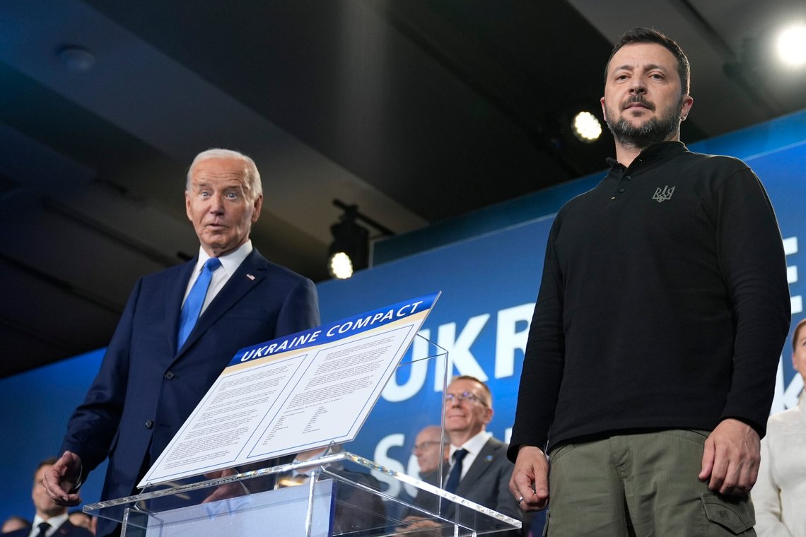 President Joe Biden, left, and President of Ukraine Volodymyr Zelenskyy pose alongside the Ukraine Compact during an event on the sidelines of the NATO Summit in Washington, Thursday, July 11, 2024. Biden launched the Ukraine Compact, signed by 25 countries and the European Union, as part of a commitment to Ukraine's long term security. (AP Photo/Susan Walsh) President Joe Biden, left, and President of Ukraine Volodymyr Zelenskyy pose alongside the Ukraine Compact during an event on the sidelines of the NATO Summit in Washington, Thursday, July 11, 2024. Biden launched the Ukraine Compact, signed by 25 countries and the European Union, as part of a commitment to Ukraine's long term security. (AP Photo/Susan Walsh)