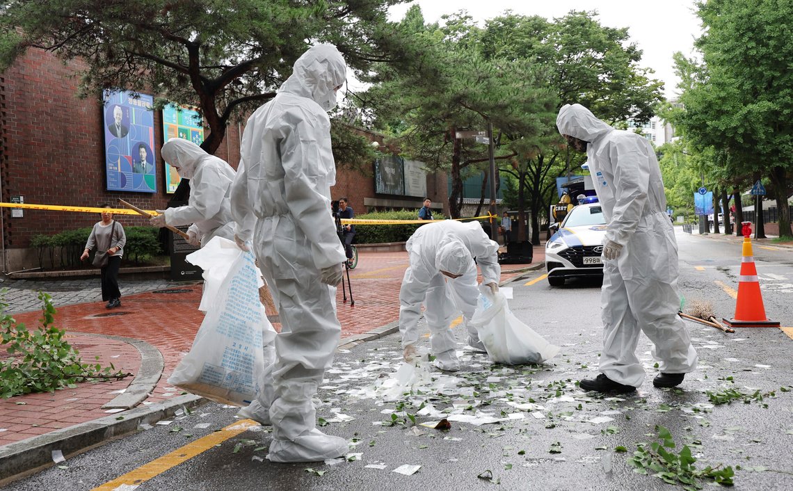 Officers wearing protective gear collect the trash from a balloon presumably sent by North Korea, Wednesday, July 24, 2024, in Seoul, South Korea. (Park Dong-joo/Yonhap via AP) Officers wearing protective gear collect the trash from a balloon presumably sent by North Korea, Wednesday, July 24, 2024, in Seoul, South Korea. (Park Dong-joo/Yonhap via AP)