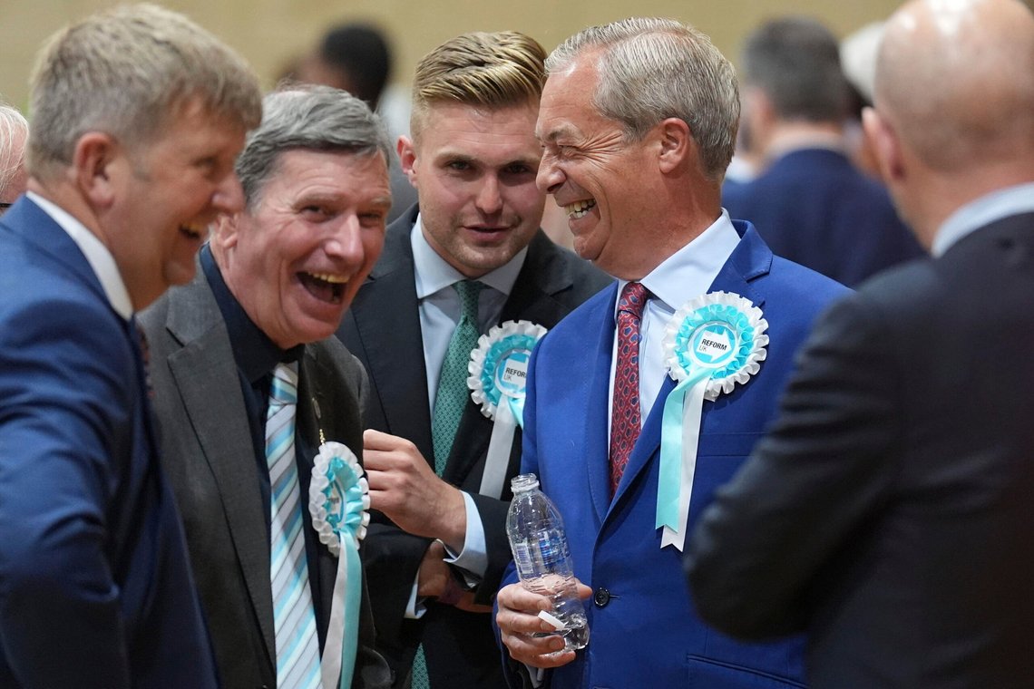 Reform UK leader Nigel Farage, second right, arrives at Clacton Leisure Centre in Clacton, England, during the count for the 2024 General Election, Friday July 5, 2024. Britain's Labour Party headed for a landslide victory Friday in a parliamentary election, an exit poll suggested, as voters punished the governing Conservatives after 14 years of economic and political upheaval. (Joe Giddens/PA Wire/PA via AP) Reform UK leader Nigel Farage, second right, arrives at Clacton Leisure Centre in Clacton, England, during the count for the 2024 General Election, Friday July 5, 2024. Britain's Labour Party headed for a landslide victory Friday in a parliamentary election, an exit poll suggested, as voters punished the governing Conservatives after 14 years of economic and political upheaval. (Joe Giddens/PA Wire/PA via AP)