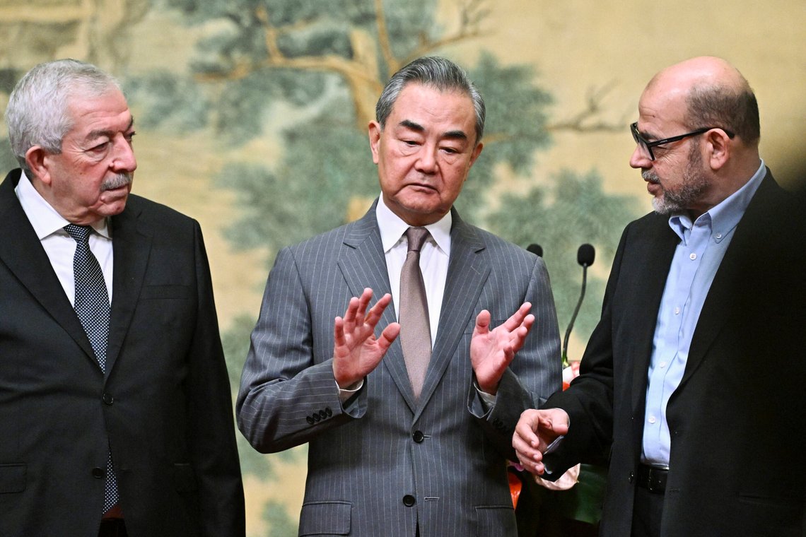 China's Foreign Minister Wang Yi, center, hosts an event for Mahmoud al-Aloul, left, vice chairman of Fatah, and Mussa Abu Marzuk, a senior member of Hamas, to meet at the Diaoyutai State Guesthouse in Beijing, Tuesday, July 23, 2024. (Pedro Pardo/Pool Photo via AP) China's Foreign Minister Wang Yi, center, hosts an event for Mahmoud al-Aloul, left, vice chairman of Fatah, and Mussa Abu Marzuk, a senior member of Hamas, to meet at the Diaoyutai State Guesthouse in Beijing, Tuesday, July 23, 2024. (Pedro Pardo/Pool Photo via AP)