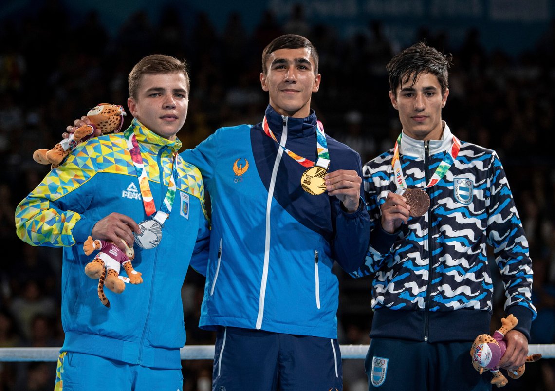 In this photo provided by the International Olympic Committee, from left, silver medalist Maksym Halinichev of Ukraine, gold medalist Abdumalik Khalokov of Uzbekistan and bronze medalist Mirco Jehiel Cuello of Argentina stand together during the medal ceremony for the Boxing Mens Bantam (up to 56kg) during The Youth Olympic Games in Buenos Aires, Thursday, Oct. 18, 2018. Halinichev considered the bout a loss – it wasn’t gold, after all – but it gave him a map for the future. (Thomas Lovelock/IOC via AP) In this photo provided by the International Olympic Committee, from left, silver medalist Maksym Halinichev of Ukraine, gold medalist Abdumalik Khalokov of Uzbekistan and bronze medalist Mirco Jehiel Cuello of Argentina stand together during the medal ceremony for the Boxing Mens Bantam (up to 56kg) during The Youth Olympic Games in Buenos Aires, Thursday, Oct. 18, 2018. Halinichev considered the bout a loss – it wasn’t gold, after all – but it gave him a map for the future. (Thomas Lovelock/IOC via AP)