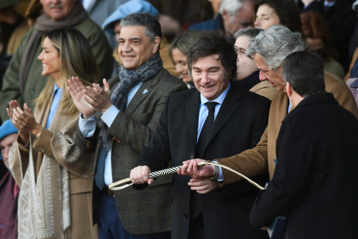 Argentine President Javier Milei, center right, receives a horsewhip during the opening ceremony for the Rural Society's annual exposition in Buenos Aires, Argentina, Sunday, July 28, 2024. (AP Photo/Gustavo Garello) Argentine President Javier Milei, center right, receives a horsewhip during the opening ceremony for the Rural Society's annual exposition in Buenos Aires, Argentina, Sunday, July 28, 2024. (AP Photo/Gustavo Garello)