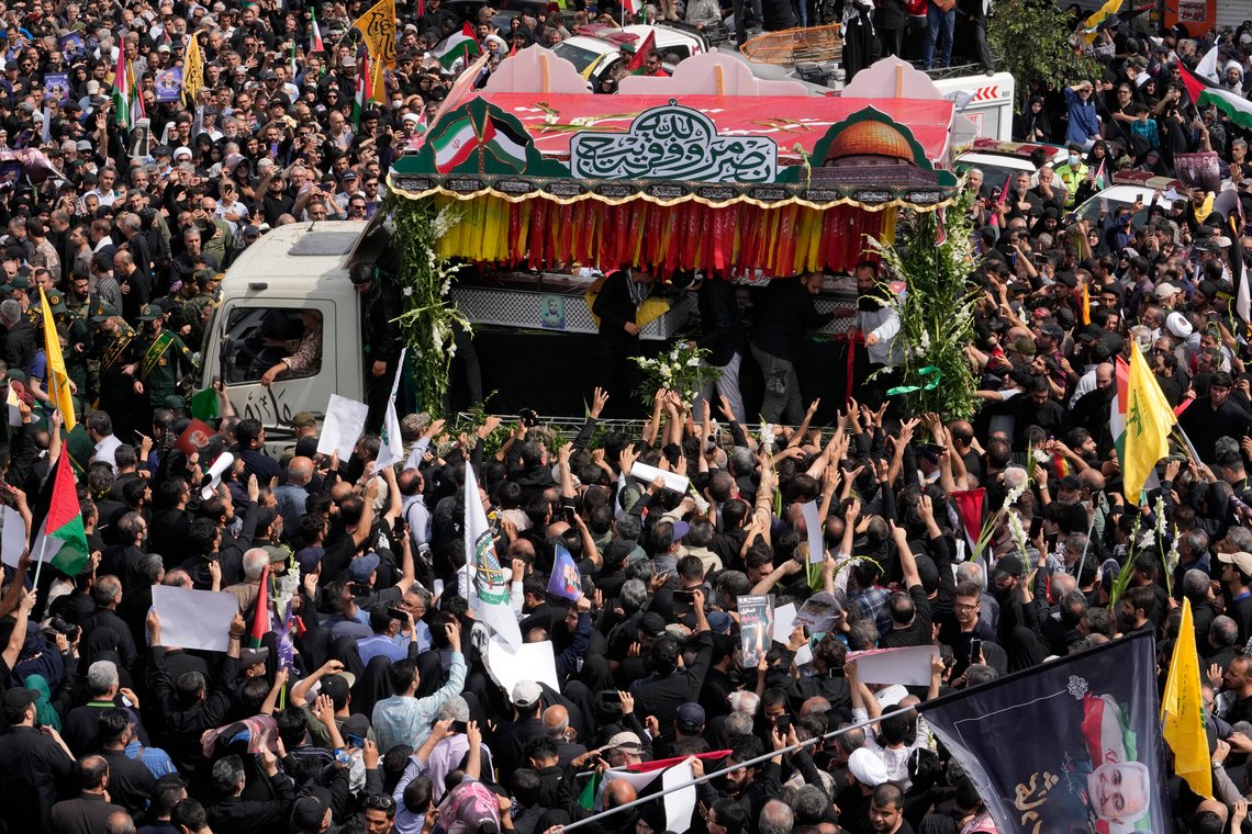 Iranians follow the truck carrying the coffins of Hamas leader Ismail Haniyeh and his bodyguard, who were killed in an assassination blamed on Israel on Wednesday, during their funeral ceremony at Enqelab-e-Eslami (Islamic Revolution) Sq. in Tehran, Iran, Thursday, Aug. 1, 2024. (AP Photo/Vahid Salemi) Iranians follow the truck carrying the coffins of Hamas leader Ismail Haniyeh and his bodyguard, who were killed in an assassination blamed on Israel on Wednesday, during their funeral ceremony at Enqelab-e-Eslami (Islamic Revolution) Sq. in Tehran, Iran, Thursday, Aug. 1, 2024. (AP Photo/Vahid Salemi)