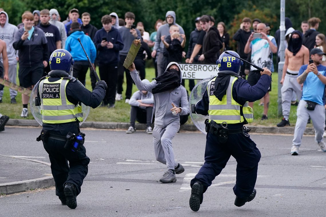 A youth throws a fence post towards police during an anti-immigration demonstration near the Holiday Inn Express hotel in Rotherham, South Yorkshire, England, on Sunday, Aug. 4, 2024. (Danny Lawson/PA via AP) A youth throws a fence post towards police during an anti-immigration demonstration near the Holiday Inn Express hotel in Rotherham, South Yorkshire, England, on Sunday, Aug. 4, 2024. (Danny Lawson/PA via AP)