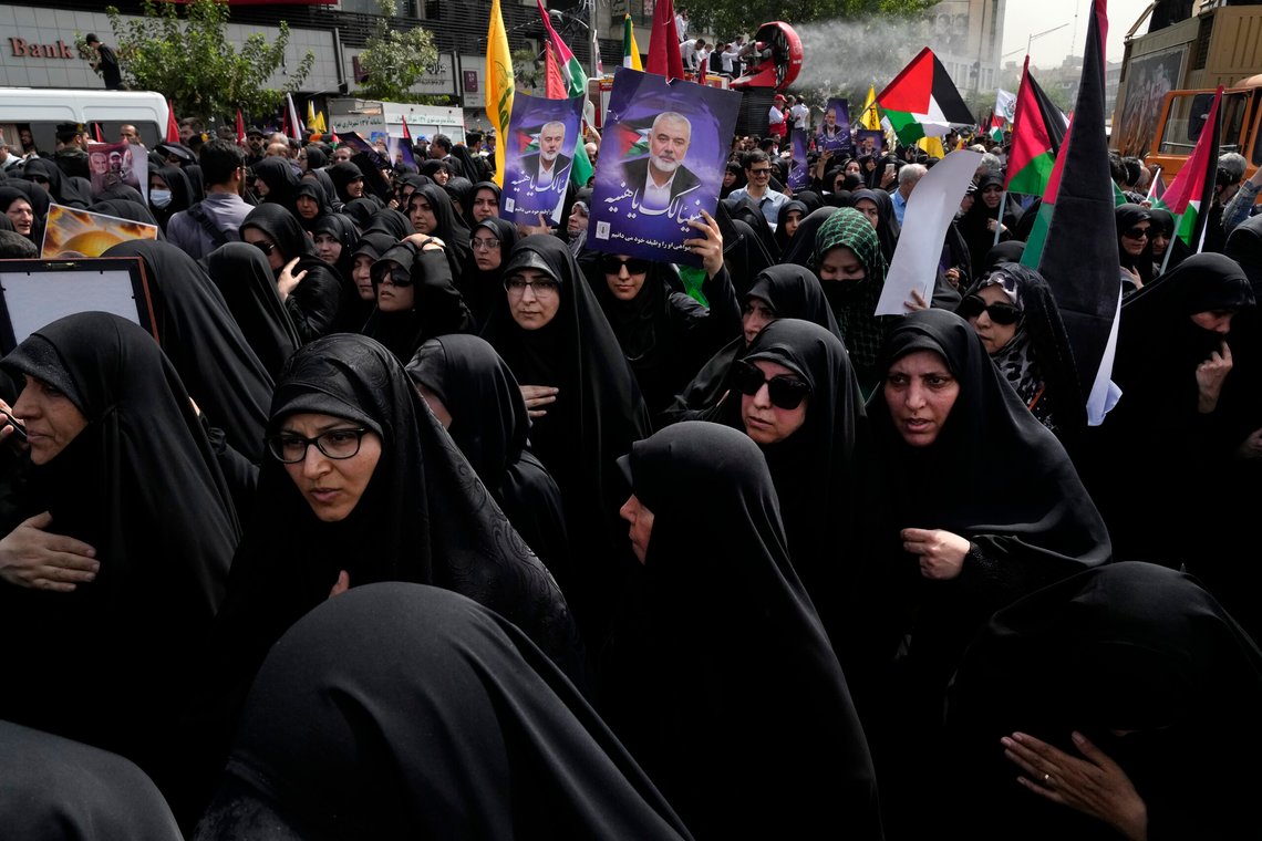 Iranians attend the funeral ceremony of Hamas leader Ismail Haniyeh and his bodyguard, some of them holding up posters with his photo and reading in Arabic: "Congratulations Haniyeh!" at Enqelab-e-Eslami (Islamic Revolution) Sq. in Tehran, Iran, Thursday, Aug. 1, 2024. (AP Photo/Vahid Salemi) Iranians attend the funeral ceremony of Hamas leader Ismail Haniyeh and his bodyguard, some of them holding up posters with his photo and reading in Arabic: "Congratulations Haniyeh!" at Enqelab-e-Eslami (Islamic Revolution) Sq. in Tehran, Iran, Thursday, Aug. 1, 2024. (AP Photo/Vahid Salemi)