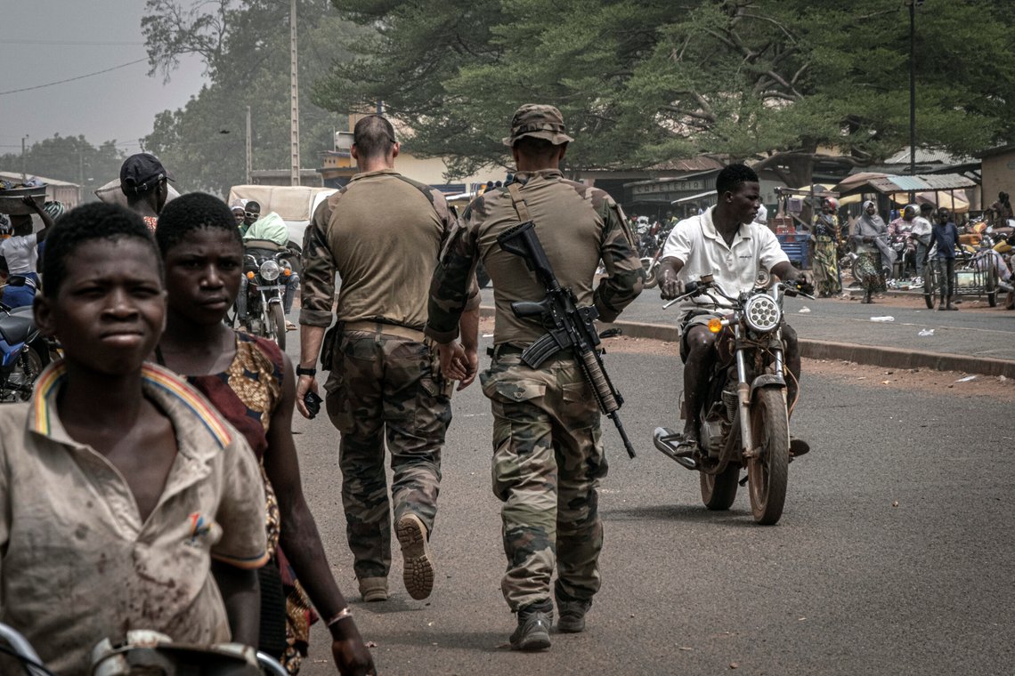 FILE - French army military instructors walk on one of the main roads in Tanguietan, northern Benin, March 28, 2022. Groups linked to al-Qaida and the Islamic State have been spreading from the vast, arid expanse south of the Sahara Desert into wealthier nations on the coast of West Africa. The jihadis' activity in Benin is concentrated in the north of the country, and people there live in constant fear because of the jihadi threat. (AP Photo/ Marco Simoncelli, File) FILE - French army military instructors walk on one of the main roads in Tanguietan, northern Benin, March 28, 2022. Groups linked to al-Qaida and the Islamic State have been spreading from the vast, arid expanse south of the Sahara Desert into wealthier nations on the coast of West Africa. The jihadis' activity in Benin is concentrated in the north of the country, and people there live in constant fear because of the jihadi threat. (AP Photo/ Marco Simoncelli, File)