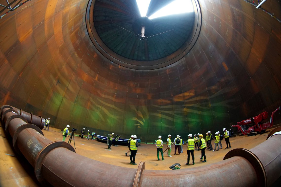 Journalist are seen inside a vast thermal tank to store hot water in Berlin, Germany, Thursday, June 30, 2022. Power provider Vattenfall unveiled a new facility in Berlin on Thursday that turns solar and wind energy into heat, which can be stored in a vast thermal tank and released into the German capital's grid as needed, smoothing out the fluctuating supply problem of renewables. (AP Photo/Michael Sohn) Journalist are seen inside a vast thermal tank to store hot water in Berlin, Germany, Thursday, June 30, 2022. Power provider Vattenfall unveiled a new facility in Berlin on Thursday that turns solar and wind energy into heat, which can be stored in a vast thermal tank and released into the German capital's grid as needed, smoothing out the fluctuating supply problem of renewables. (AP Photo/Michael Sohn)