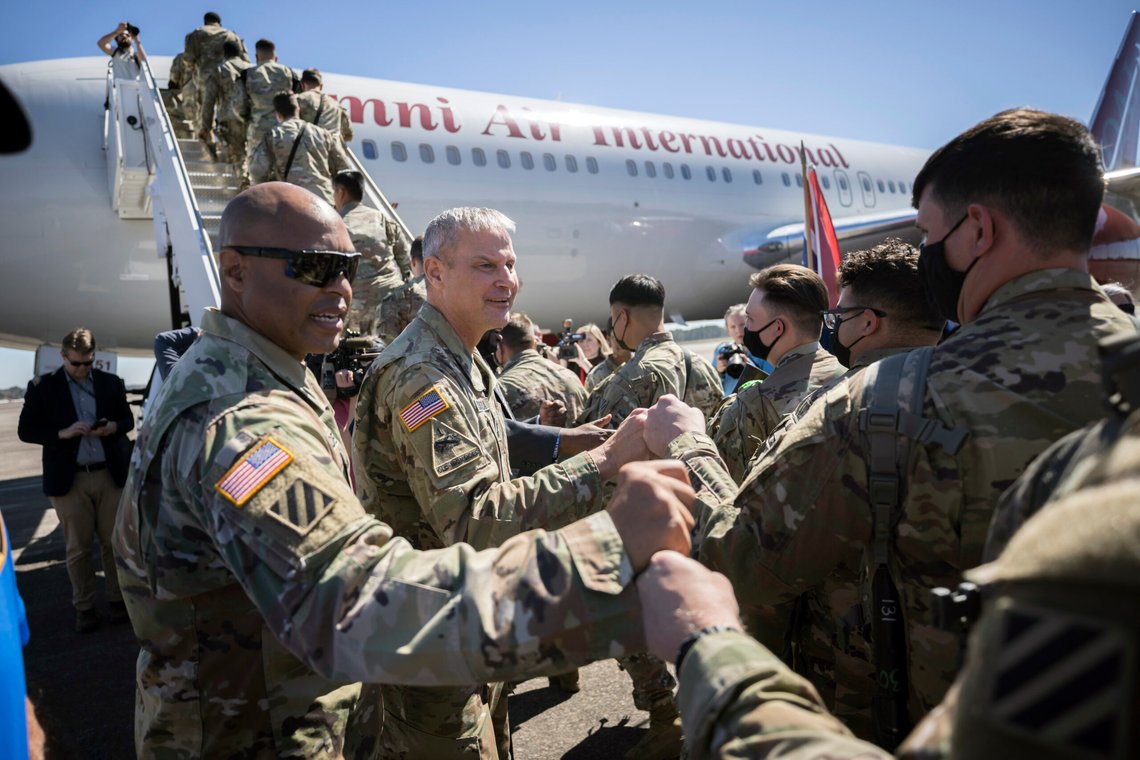 Command Sergeant Major Quentin Fenderson, center, and Major General Charles Costanza fist bump soldiers with the U.S. Army 3rd Infantry Division, 1st Armored Brigade Combat Team as they board an airplane at Hunter Army Airfield during their deployment to Germany, Wednesday March 2, 2022 in Savannah, Ga. The division is sending 3,800 troops as reinforcements for various NATO allies in Eastern Europe. (Stephen B. Morton /Atlanta Journal-Constitution via AP) Command Sergeant Major Quentin Fenderson, center, and Major General Charles Costanza fist bump soldiers with the U.S. Army 3rd Infantry Division, 1st Armored Brigade Combat Team as they board an airplane at Hunter Army Airfield during their deployment to Germany, Wednesday March 2, 2022 in Savannah, Ga. The division is sending 3,800 troops as reinforcements for various NATO allies in Eastern Europe. (Stephen B. Morton /Atlanta Journal-Constitution via AP)
