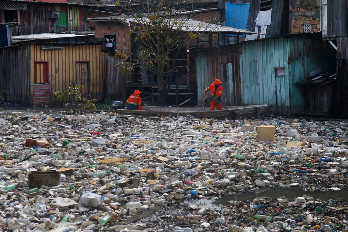 FILE - City workers remove garbage floating on the Negro River, which has a rising water level due to rain, in Manaus, Amazonas state, Brazil, June 6, 2022. (AP Photo/Edmar Barros, File) FILE - City workers remove garbage floating on the Negro River, which has a rising water level due to rain, in Manaus, Amazonas state, Brazil, June 6, 2022. (AP Photo/Edmar Barros, File)