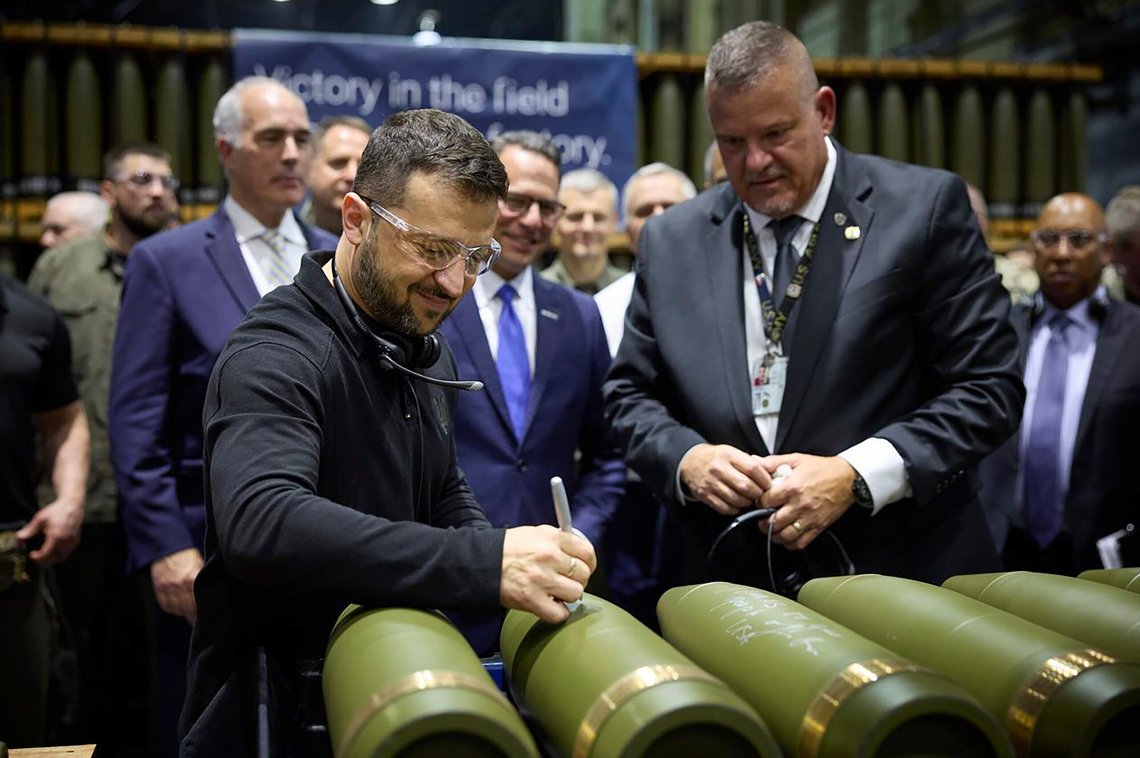In this image provided by the Office of the Ukrainian Presidency, Ukrainian President Volodymyr Zelenskyy, left, is watched by Rich Hansen, the commander's representative for the Scranton Army Ammunition Plant, while signing military ordnance in Scranton, Pa., Sunday, Sept. 22, 2024. (Office of the Ukrainian Presidency via AP) In this image provided by the Office of the Ukrainian Presidency, Ukrainian President Volodymyr Zelenskyy, left, is watched by Rich Hansen, the commander's representative for the Scranton Army Ammunition Plant, while signing military ordnance in Scranton, Pa., Sunday, Sept. 22, 2024. (Office of the Ukrainian Presidency via AP)