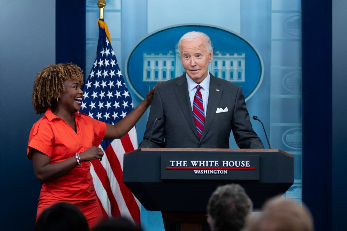 President Joe Biden stands next to White House press secretary Karine Jean-Pierre when Biden made a surprise appearance during the daily briefing at the White House in Washington, Friday, Oct. 4, 2024. (AP Photo/Ben Curtis) President Joe Biden stands next to White House press secretary Karine Jean-Pierre when Biden made a surprise appearance during the daily briefing at the White House in Washington, Friday, Oct. 4, 2024. (AP Photo/Ben Curtis)