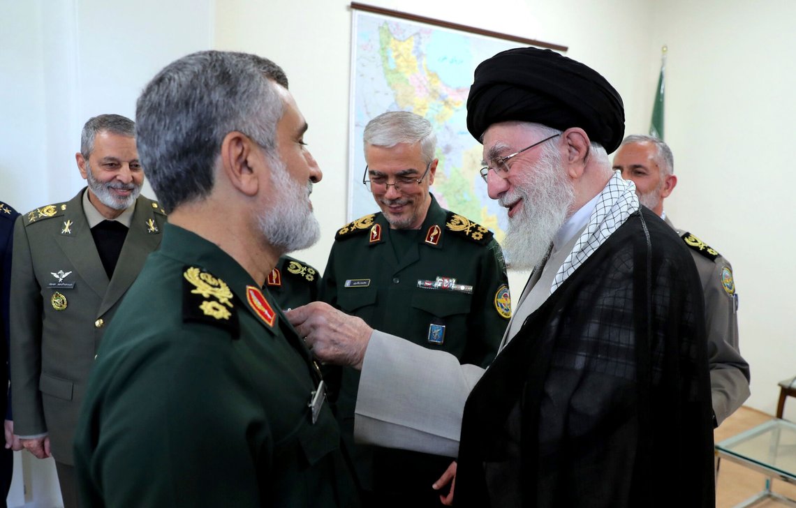 In this photo released by the official website of the office of the Iranian supreme leader, Supreme Leader Ayatollah Ali Khamenei awards Revolutionary Guard aerospace division commander Gen. Amir Ali Hajizadeh with Fath medal of honor in a ceremony in Tehran, Iran, Sunday, Oct. 6, 2024. Chief of the General Staff of the Armed Forces Gen. Mohammad Hossein Bagheri, center, and the army commander Gen. Abdolrahim Mousavi, left, look on. (Office of the Iranian Supreme Leader via AP) In this photo released by the official website of the office of the Iranian supreme leader, Supreme Leader Ayatollah Ali Khamenei awards Revolutionary Guard aerospace division commander Gen. Amir Ali Hajizadeh with Fath medal of honor in a ceremony in Tehran, Iran, Sunday, Oct. 6, 2024. Chief of the General Staff of the Armed Forces Gen. Mohammad Hossein Bagheri, center, and the army commander Gen. Abdolrahim Mousavi, left, look on. (Office of the Iranian Supreme Leader via AP)