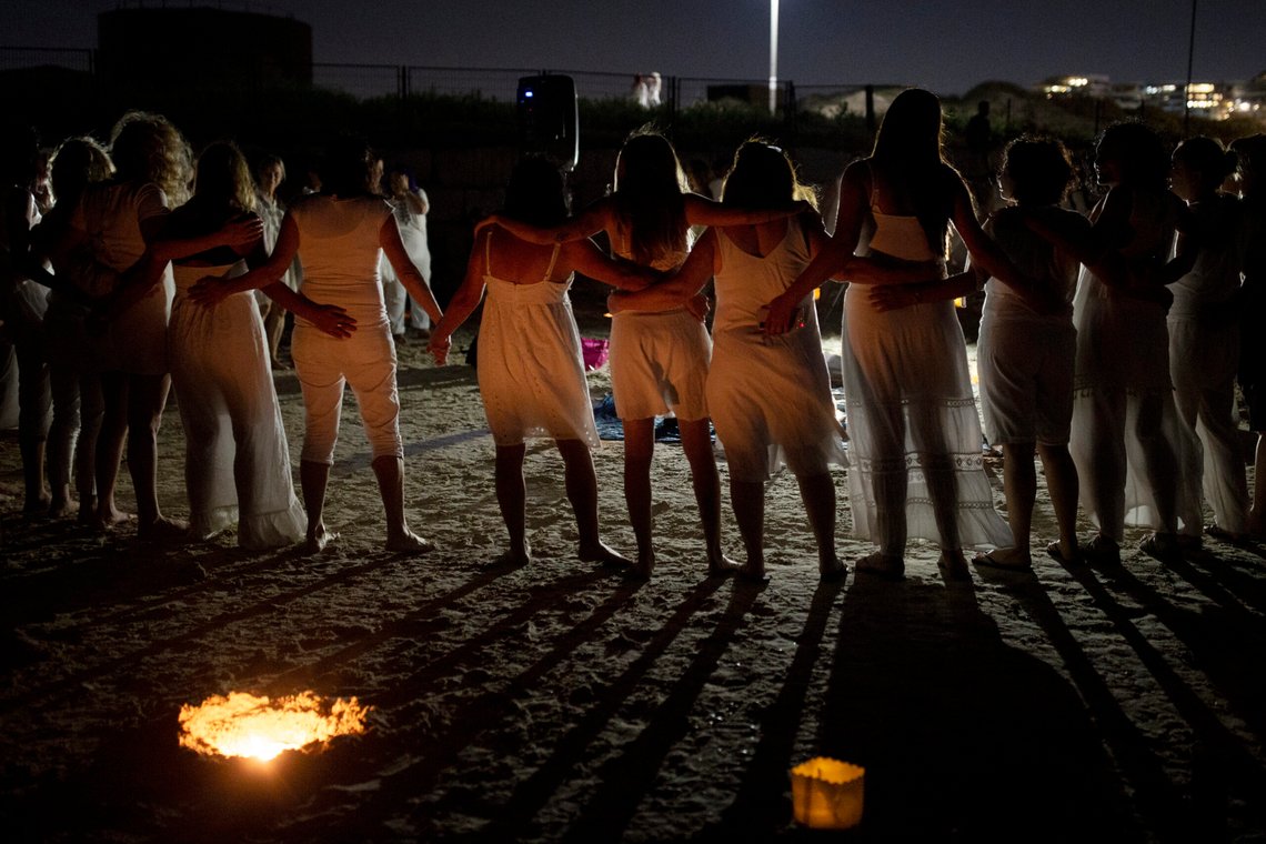 Women take part in a Tashlich ceremony, where they wrote down things they want to release before casting them into a fire, on the beach in Tel Aviv, Israel, Tuesday, Sept. 14, 2021. Tashlich, which means 'to cast away' in Hebrew, is the practice by which Jews go to a large flowing body of water and symbolically 'throw away' their sins by throwing a piece of bread, or similar food, into the water before the Jewish holiday of Yom Kippur, the holiest day in the Jewish year which starts at sundown Wednesday. (AP Photo/Maya Alleruzzo) Women take part in a Tashlich ceremony, where they wrote down things they want to release before casting them into a fire, on the beach in Tel Aviv, Israel, Tuesday, Sept. 14, 2021. Tashlich, which means 'to cast away' in Hebrew, is the practice by which Jews go to a large flowing body of water and symbolically 'throw away' their sins by throwing a piece of bread, or similar food, into the water before the Jewish holiday of Yom Kippur, the holiest day in the Jewish year which starts at sundown Wednesday. (AP Photo/Maya Alleruzzo)