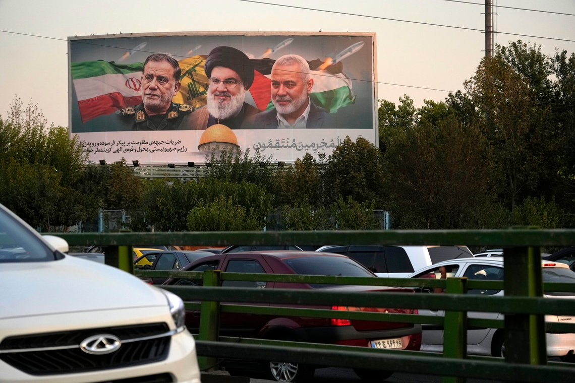 Vehicles drive past a billboard on a highway in Tehran, Iran, Monday, Oct. 7, 2024, showing slain Hezbollah leader Hassan Nasrallah, center, late Hamas leader Ismail Haniyeh, right, and the late Iranian Revolutionary Guard Gen. Abbas Nilforushan, who was killed in an Israeli airstrike. The billboard contains a verse of Quran that reads: "We will surely inflict punishment upon the wicked." (AP Photo/Vahid Salemi) Vehicles drive past a billboard on a highway in Tehran, Iran, Monday, Oct. 7, 2024, showing slain Hezbollah leader Hassan Nasrallah, center, late Hamas leader Ismail Haniyeh, right, and the late Iranian Revolutionary Guard Gen. Abbas Nilforushan, who was killed in an Israeli airstrike. The billboard contains a verse of Quran that reads: "We will surely inflict punishment upon the wicked." (AP Photo/Vahid Salemi)