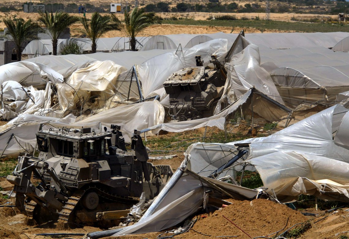 ** FILE ** Israeli army D-9 bulldozers demolish greenhouses and farming land belonging to Palestinian farmer Issa Zorob, during an army operation in the outskirts of the Tel Sultan neighborhood of Rafah's refugee camp, in the southern Gaza Strip, in this May 21, 2004 file photo. Human Rights Watch, an international human rights group has called on American heavy-equipment maker Caterpillar Inc. to suspend bulldozer sales to the Israeli military, citing the army's use of the vehicles as the army's ** FILE ** Israeli army D-9 bulldozers demolish greenhouses and farming land belonging to Palestinian farmer Issa Zorob, during an army operation in the outskirts of the Tel Sultan neighborhood of Rafah's refugee camp, in the southern Gaza Strip, in this May 21, 2004 file photo. Human Rights Watch, an international human rights group has called on American heavy-equipment maker Caterpillar Inc. to suspend bulldozer sales to the Israeli military, citing the army's use of the vehicles as the army's
