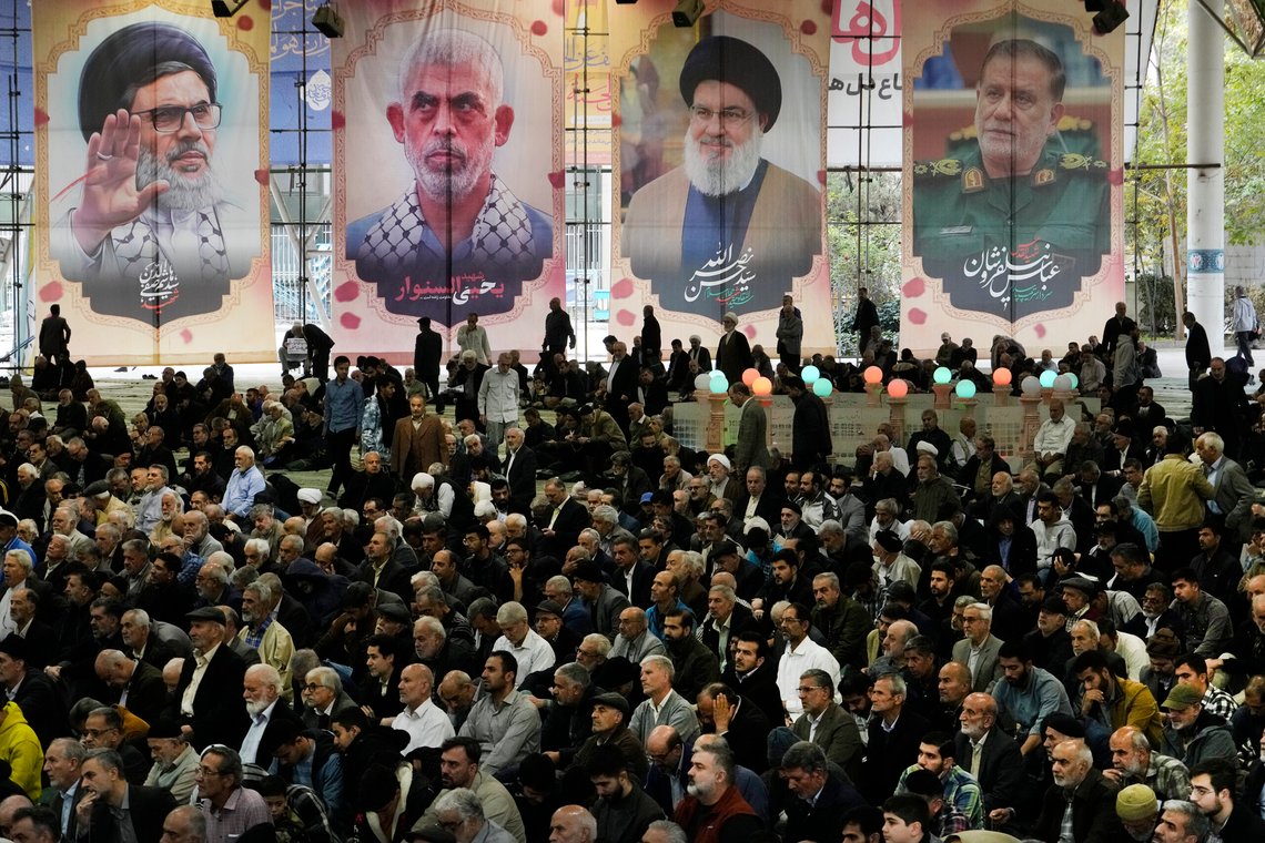 Iranian worshippers sit under portraits of Iranian Revolutionary Guard Gen. Abbas Nilforushan, right, Hezbollah leader Hassan Nasrallah, second right, Hamas leader Yahya Sinwar, second left, and Nasrallah's presumed successor, Hashem Safieddine, all of whom were killed by Israeli strikes, during Friday prayer ceremony at the Tehran University campus, Friday, Nov. 8, 2024, in Tehran, Iran. (AP Photo/Vahid Salemi) Iranian worshippers sit under portraits of Iranian Revolutionary Guard Gen. Abbas Nilforushan, right, Hezbollah leader Hassan Nasrallah, second right, Hamas leader Yahya Sinwar, second left, and Nasrallah's presumed successor, Hashem Safieddine, all of whom were killed by Israeli strikes, during Friday prayer ceremony at the Tehran University campus, Friday, Nov. 8, 2024, in Tehran, Iran. (AP Photo/Vahid Salemi)