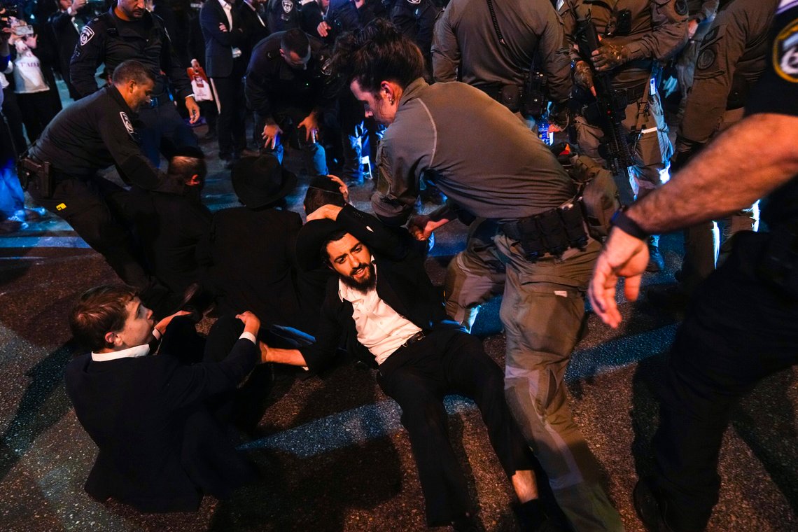 Israeli police officers disperse Ultra-Orthodox Jewish blocking a road during a protest against army recruitment in Bnei Brak, near Tel Aviv, Israel, Sunday, Nov. 17, 2024. (AP Photo/Francisco Seco) Israeli police officers disperse Ultra-Orthodox Jewish blocking a road during a protest against army recruitment in Bnei Brak, near Tel Aviv, Israel, Sunday, Nov. 17, 2024. (AP Photo/Francisco Seco)