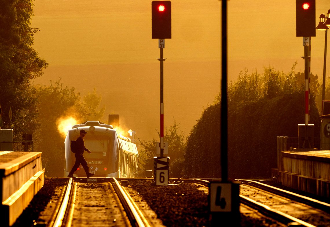 A man crosses rails as a regional hydrogen train leaves the station of Wehrheim near Frankfurt, Germany, early Tuesday, Sept. 10, 2024. (AP Photo/Michael Probst) A man crosses rails as a regional hydrogen train leaves the station of Wehrheim near Frankfurt, Germany, early Tuesday, Sept. 10, 2024. (AP Photo/Michael Probst)