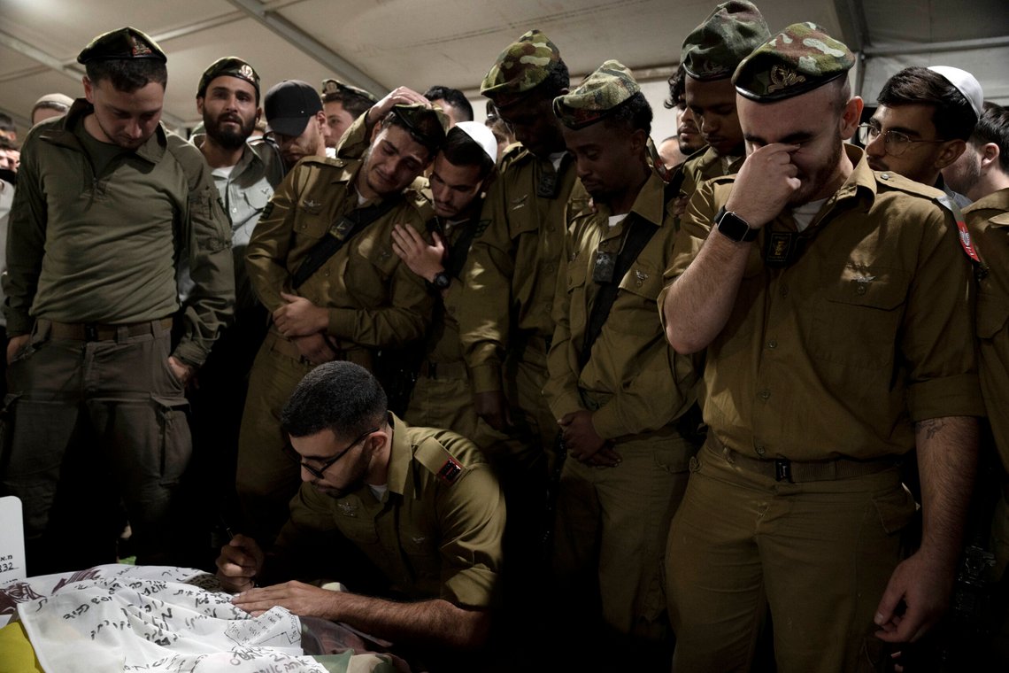 Israeli Defense Forces soldiers mourn at the grave of Sgt. First Class (res.) Roi Sasson, who was killed in action in the Gaza Strip, during his funeral at Mt. Herzl military cemetery in Jerusalem, Wednesday, Nov. 20, 2024. (AP Photo/Maya Alleruzzo) Israeli Defense Forces soldiers mourn at the grave of Sgt. First Class (res.) Roi Sasson, who was killed in action in the Gaza Strip, during his funeral at Mt. Herzl military cemetery in Jerusalem, Wednesday, Nov. 20, 2024. (AP Photo/Maya Alleruzzo)