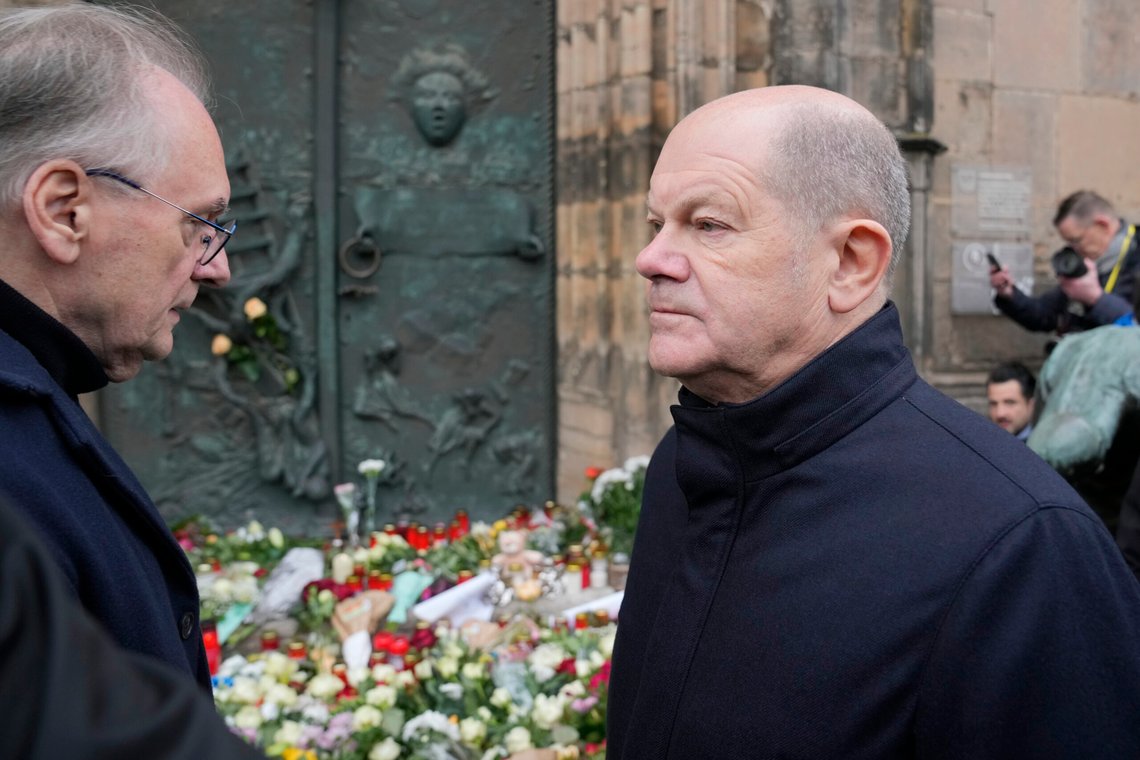 The Chancellor of Germany Olaf Scholz, right, arrives outside St. John's Church to lay some flowers near a Christmas Market, where a car drove into a crowd on Friday evening, in Magdeburg, Germany, Saturday, Dec. 21, 2024. (AP Photo/Ebrahim Noroozi) The Chancellor of Germany Olaf Scholz, right, arrives outside St. John's Church to lay some flowers near a Christmas Market, where a car drove into a crowd on Friday evening, in Magdeburg, Germany, Saturday, Dec. 21, 2024. (AP Photo/Ebrahim Noroozi)