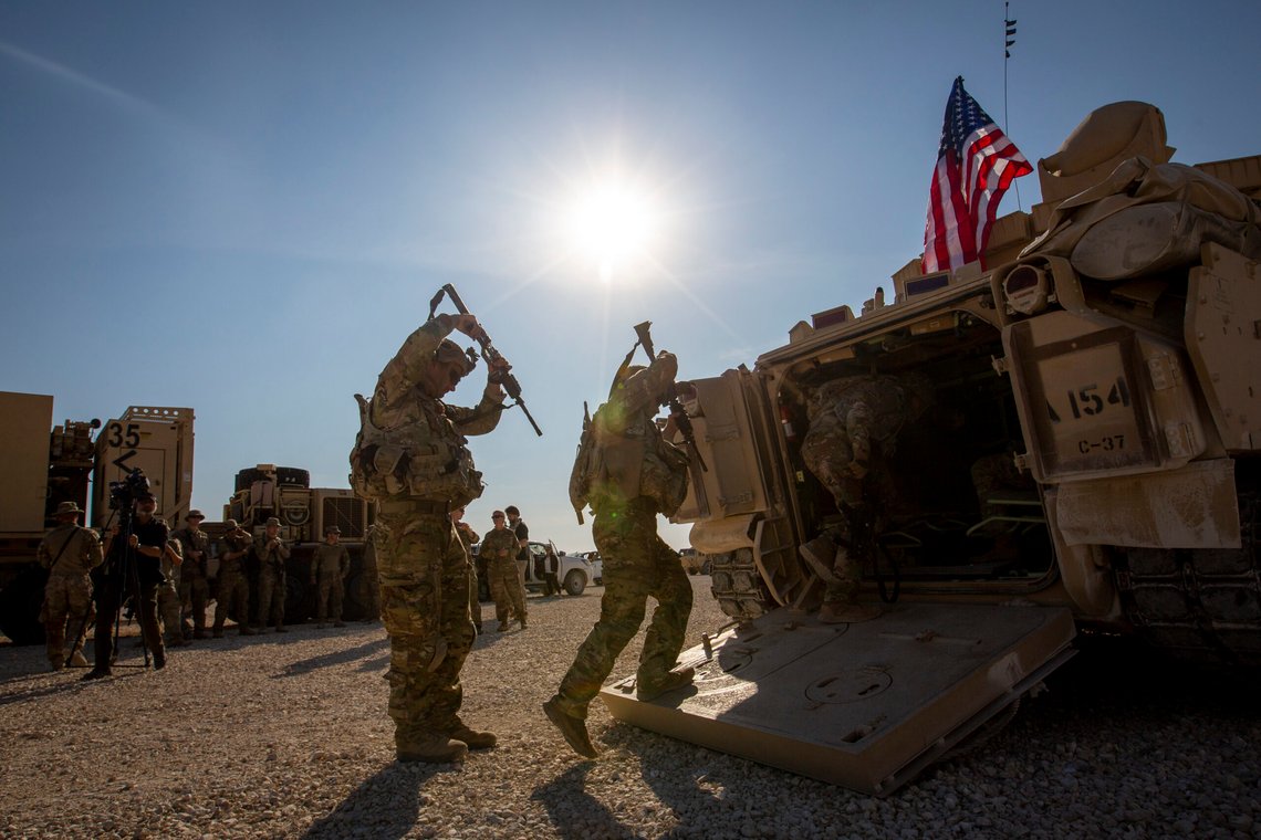 FILE - Crewmen enter Bradley fighting vehicles at a US military base at an undisclosed location in Northeastern Syria, on Nov. 11, 2019. Legislation directing President Joe Biden to remove some 900 U.S. troops from Syria within 180 days was soundly defeated in the House on Wednesday, March 8, 2023, as opponents of the measure warned that it could allow a dismantled Islamic State group to reorganize and endanger the U.S. and its allies. (AP Photo/Darko Bandic, File) FILE - Crewmen enter Bradley fighting vehicles at a US military base at an undisclosed location in Northeastern Syria, on Nov. 11, 2019. Legislation directing President Joe Biden to remove some 900 U.S. troops from Syria within 180 days was soundly defeated in the House on Wednesday, March 8, 2023, as opponents of the measure warned that it could allow a dismantled Islamic State group to reorganize and endanger the U.S. and its allies. (AP Photo/Darko Bandic, File)