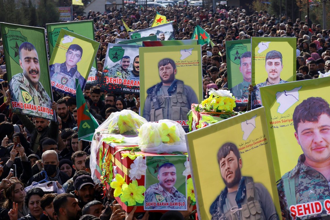 The coffins of two of six Kurdish fighters from the Syrian Democratic Forces (SDF) killed in ongoing clashes with Turkish-backed militias in northern Syria are carried during their funeral in Qamishli, northeastern Syria, Thursday, Dec. 26, 2024. (AP Photo/Hogir El Abdo) The coffins of two of six Kurdish fighters from the Syrian Democratic Forces (SDF) killed in ongoing clashes with Turkish-backed militias in northern Syria are carried during their funeral in Qamishli, northeastern Syria, Thursday, Dec. 26, 2024. (AP Photo/Hogir El Abdo)
