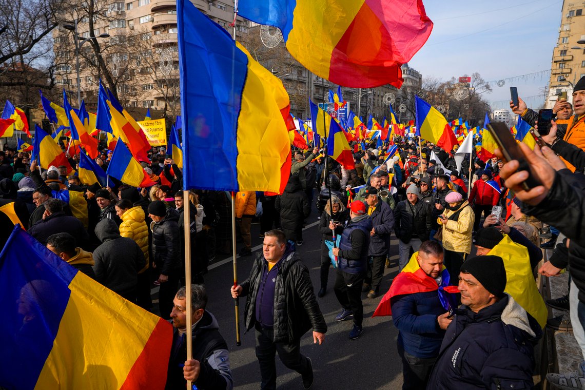 Protesters walk holding Romanian flags during a rally organized by the right wing Alliance for the Unity of Romanians (AUR), calling for free elections after Romania' s Constitutional Court annulled the first round of presidential elections last December, in Bucharest, Romania, Sunday, Jan. 12, 2025. (AP Photo/Vadim Ghirda) Protesters walk holding Romanian flags during a rally organized by the right wing Alliance for the Unity of Romanians (AUR), calling for free elections after Romania' s Constitutional Court annulled the first round of presidential elections last December, in Bucharest, Romania, Sunday, Jan. 12, 2025. (AP Photo/Vadim Ghirda)