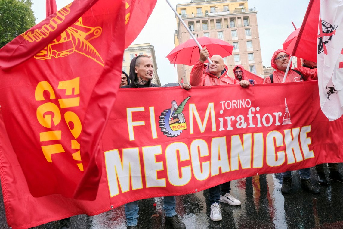 Demonstrators wave union flags on the occasion of a national strike of metalworkers of the automotive sector for the first time in 20 years, in Rome, Friday, Oct. 18 2024. Writing on banner reads in Italian"Turin Mirafiori Mecchanics". (Mauro Scrobogna/LaPresse via AP) Demonstrators wave union flags on the occasion of a national strike of metalworkers of the automotive sector for the first time in 20 years, in Rome, Friday, Oct. 18 2024. Writing on banner reads in Italian"Turin Mirafiori Mecchanics". (Mauro Scrobogna/LaPresse via AP)