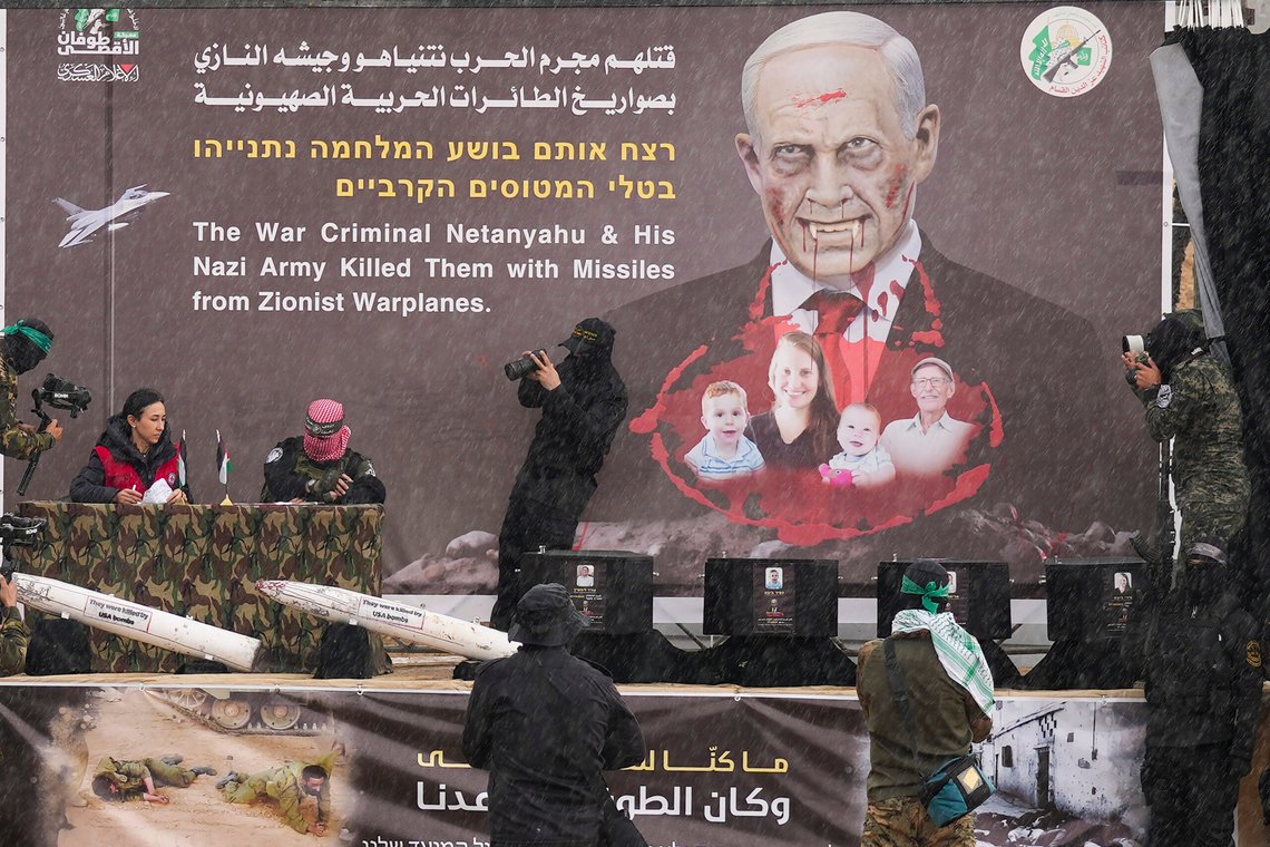 Hamas fighters hand over the coffins containing the bodies of four Israeli hostages, including a mother and her two children, who had long been feared dead, to the Red Cross in Khan Younis, southern Gaza Strip, Thursday, Feb. 20, 2025. (AP Photo/Abdel Kareem Hana) Hamas fighters hand over the coffins containing the bodies of four Israeli hostages, including a mother and her two children, who had long been feared dead, to the Red Cross in Khan Younis, southern Gaza Strip, Thursday, Feb. 20, 2025. (AP Photo/Abdel Kareem Hana)