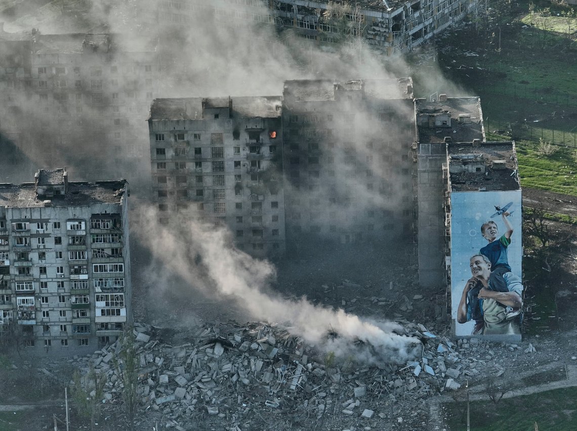 FILE - Smoke rises from a building in Bakhmut, the site of the heaviest battles with the Russian troops in the Donetsk region, Ukraine, Wednesday, April 26, 2023. Russia has accelerated its destruction of Ukraine's front-line cities in 2024 to a scale never seen in the war using glide bombs, first used in Bakhmut and Avdiivka, and an expanding network of airstrips.(AP Photo/Libkos,File) FILE - Smoke rises from a building in Bakhmut, the site of the heaviest battles with the Russian troops in the Donetsk region, Ukraine, Wednesday, April 26, 2023. Russia has accelerated its destruction of Ukraine's front-line cities in 2024 to a scale never seen in the war using glide bombs, first used in Bakhmut and Avdiivka, and an expanding network of airstrips.(AP Photo/Libkos,File)