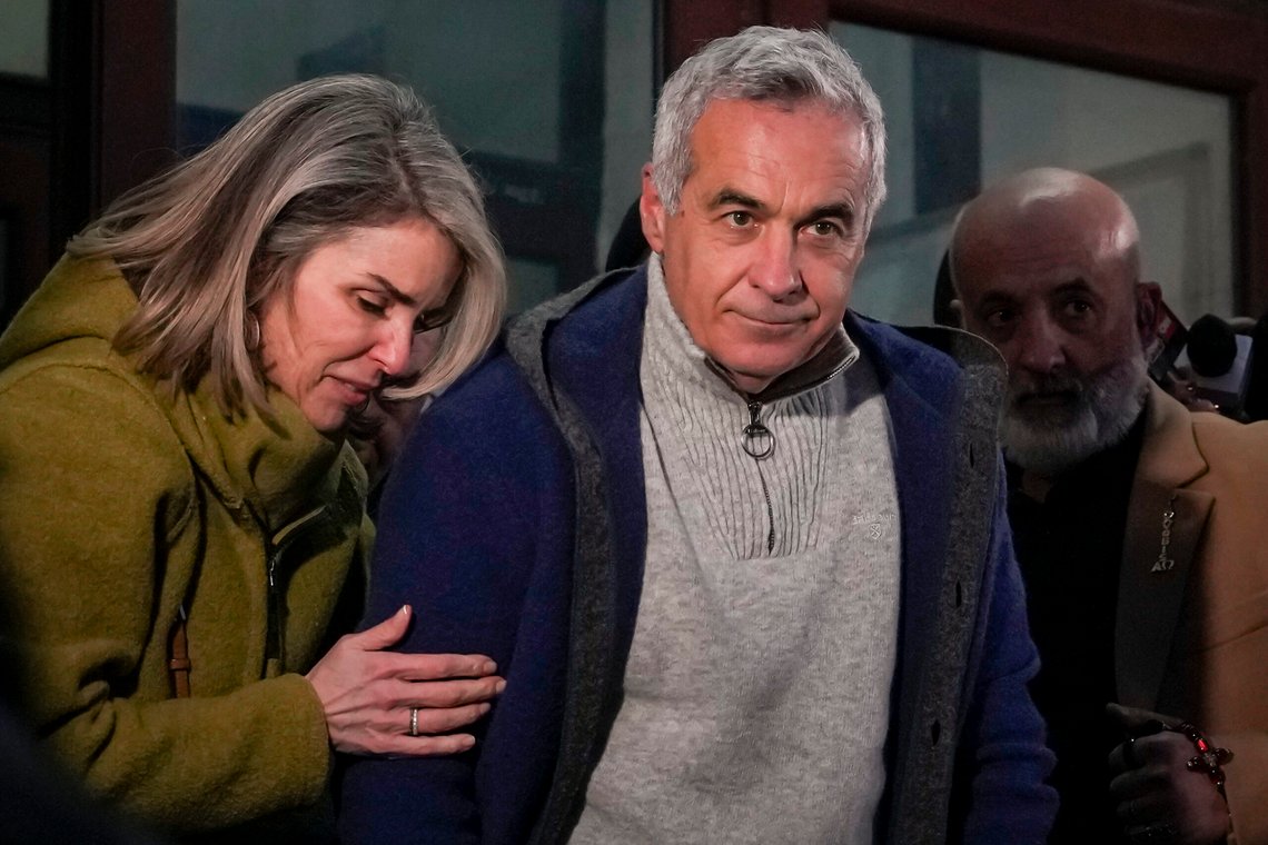 Calin Georgescu, the winner of Romania's first round of presidential election, annulled by the Constitutional Court, and his wife Cristela, leave the prosecutors office after being stopped in traffic and taken in for questioning in Bucharest, Romania, Wednesday, Feb. 26, 2025. (AP Photo/Vadim Ghirda) Calin Georgescu, the winner of Romania's first round of presidential election, annulled by the Constitutional Court, and his wife Cristela, leave the prosecutors office after being stopped in traffic and taken in for questioning in Bucharest, Romania, Wednesday, Feb. 26, 2025. (AP Photo/Vadim Ghirda)