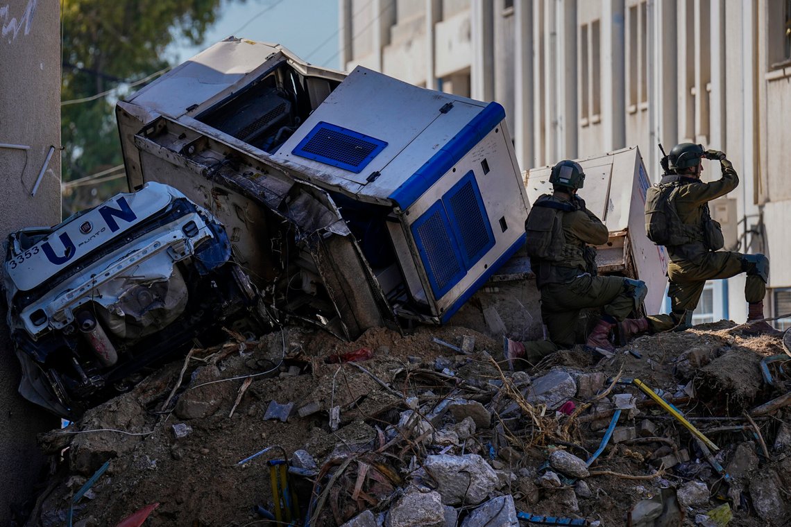 FILE - Israeli soldiers take position next to crumpled-up U.N. vehicles perched precariously atop building debris in UNRWA compound, where the military discovered tunnels in the main headquarters of the U.N. agency that the military says Hamas militants used to attack its forces during a ground operation in Gaza, Thursday, Feb. 8, 2024. (AP Photo/Ariel Schalit, File) FILE - Israeli soldiers take position next to crumpled-up U.N. vehicles perched precariously atop building debris in UNRWA compound, where the military discovered tunnels in the main headquarters of the U.N. agency that the military says Hamas militants used to attack its forces during a ground operation in Gaza, Thursday, Feb. 8, 2024. (AP Photo/Ariel Schalit, File)