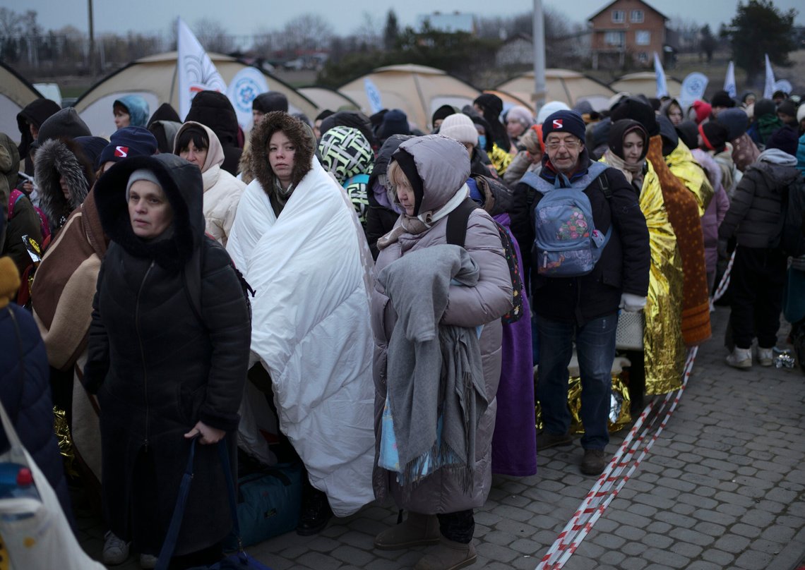 FILE - Refugees wait in a crowd for transportation after fleeing from the Ukraine and arriving at the border crossing in Medyka, Poland, March 7, 2022. (AP Photo/Markus Schreiber, File) FILE - Refugees wait in a crowd for transportation after fleeing from the Ukraine and arriving at the border crossing in Medyka, Poland, March 7, 2022. (AP Photo/Markus Schreiber, File)