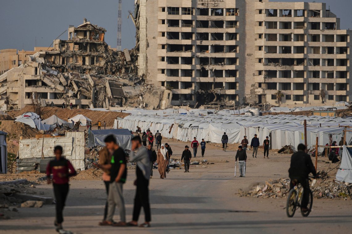 Palestinians walk next to a tent camp for displaced by the Israeli air and ground offensive on the Gaza Strip in west of Gaza Strip, Tuesday, March 25, 2025. (AP Photo/Jehad Alshrafi) Palestinians walk next to a tent camp for displaced by the Israeli air and ground offensive on the Gaza Strip in west of Gaza Strip, Tuesday, March 25, 2025. (AP Photo/Jehad Alshrafi)