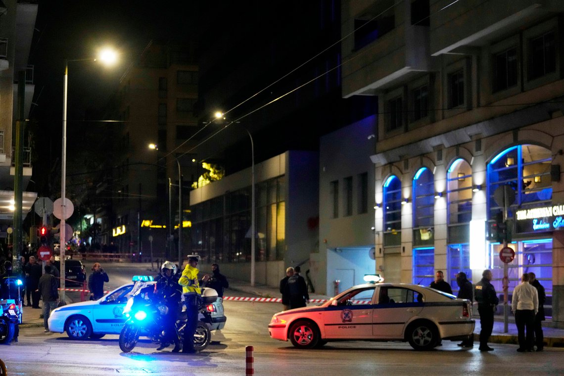 Policemen close the road after a suspected bomb explosion outside of the Hellenic Train offices the company that runs Greece's railway, the second building on the right, in Athens, Greece, Friday, April 11, 2025. (AP Photo/Petros Giannakouris) Policemen close the road after a suspected bomb explosion outside of the Hellenic Train offices the company that runs Greece's railway, the second building on the right, in Athens, Greece, Friday, April 11, 2025. (AP Photo/Petros Giannakouris)