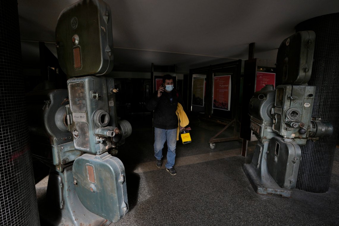 A man passes next of old movie projectors placed outside a theater in Beirut's commercial Hamra street. at the commercial Hamra Street, in Beirut, Lebanon, Wednesday, Jan. 12, 2022. The projectors were used in the past at the movie theater once known as Saroula and about a decade ago became a theater known as Metro al-Midina. Hamra Street once was home to the region's top movie theaters, shops selling international brands and cafes where intellectuals from around the Arab world gathered. Today, it reflects Lebanon's devastating multiple crises, with shuttered stores, beggars and piles of trash on the corners. (AP Photo/Hussein Malla) A man passes next of old movie projectors placed outside a theater in Beirut's commercial Hamra street. at the commercial Hamra Street, in Beirut, Lebanon, Wednesday, Jan. 12, 2022. The projectors were used in the past at the movie theater once known as Saroula and about a decade ago became a theater known as Metro al-Midina. Hamra Street once was home to the region's top movie theaters, shops selling international brands and cafes where intellectuals from around the Arab world gathered. Today, it reflects Lebanon's devastating multiple crises, with shuttered stores, beggars and piles of trash on the corners. (AP Photo/Hussein Malla)