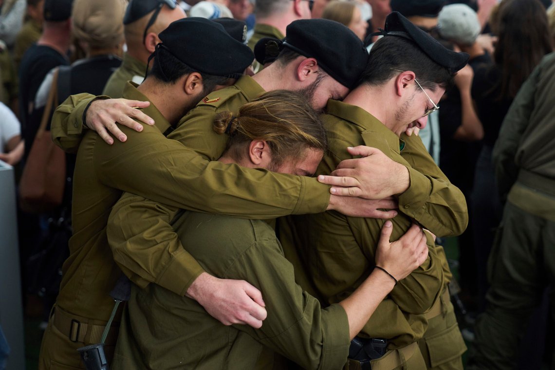 Israeli soldiers stand in a group hug as they mourn Master Sgt. (res.) Asaf Cafri, who was killed in a ground operation in the Gaza Strip, during his funeral service in the Gezer regional council of Israel, April 27, 2025. (AP Photo/Ariel Schalit) Israeli soldiers stand in a group hug as they mourn Master Sgt. (res.) Asaf Cafri, who was killed in a ground operation in the Gaza Strip, during his funeral service in the Gezer regional council of Israel, April 27, 2025. (AP Photo/Ariel Schalit)