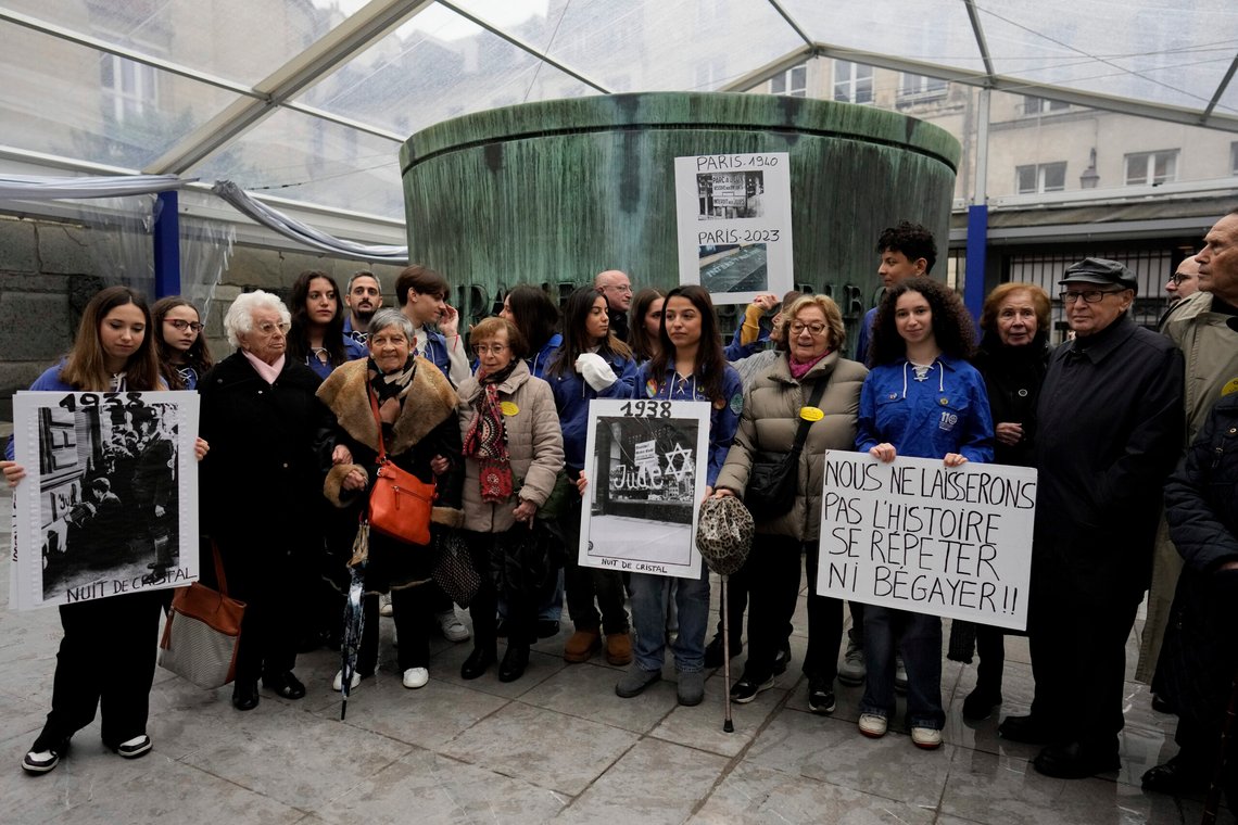 CAPTION CORRECTS NAME TO ESTHER SENOT French nazi hunter Serge Klarsfeld, right, his wife Beata, second from right, French Holocaust survivors, Esther Senot, third from left, and Ginette Kolinka, fifth from left, attend a gathering in the Paris Holocaust memorial to sound the alarm about resurgent antisemitic hate speech, graffiti and abuse linked to the Israel-Hamas war, in Paris, Saturday, Nov. 18, 2023. rance's Interior Ministry said this week that 1,762 antisemitic acts have been reported this year, as well as 131 anti-Muslim acts and 564 anti-Christian acts. The placard on the right reads "we won't let history repeat itself, or stutter". (AP Photo/Thibault Camus) CAPTION CORRECTS NAME TO ESTHER SENOT French nazi hunter Serge Klarsfeld, right, his wife Beata, second from right, French Holocaust survivors, Esther Senot, third from left, and Ginette Kolinka, fifth from left, attend a gathering in the Paris Holocaust memorial to sound the alarm about resurgent antisemitic hate speech, graffiti and abuse linked to the Israel-Hamas war, in Paris, Saturday, Nov. 18, 2023. rance's Interior Ministry said this week that 1,762 antisemitic acts have been reported this year, as well as 131 anti-Muslim acts and 564 anti-Christian acts. The placard on the right reads "we won't let history repeat itself, or stutter". (AP Photo/Thibault Camus)